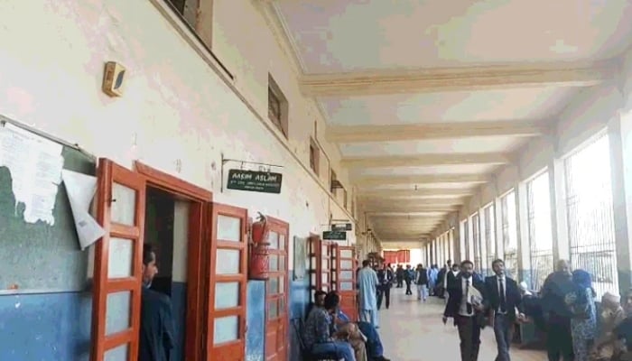 People walk through a hallway at a lower court in Karachi in this undated image. — Geo News/File