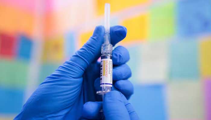 A person poses with a dose of Novavax Nuvaxovid COVID-19 vaccine in this illustration picture taken in Schwenksville, Pennsylvania, US October 2, 2025. — Reuters