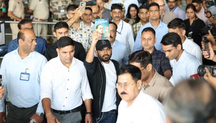 Abhijeet Dipke, head of the Cockroach Janta Party (CJP), gestures towards his supporters upon his arrival at an airport in New Delhi, India, June 6, 2026. — Reuters