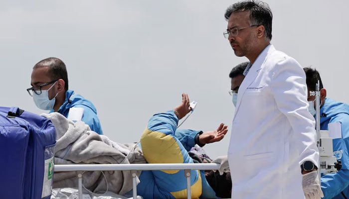 Paramedics transport Dawa Sherpa, who was missing for several days in the Everest region, from the helipad at Hams Hospital in Kathmandu, Nepal, June 4, 2026. — Reuters