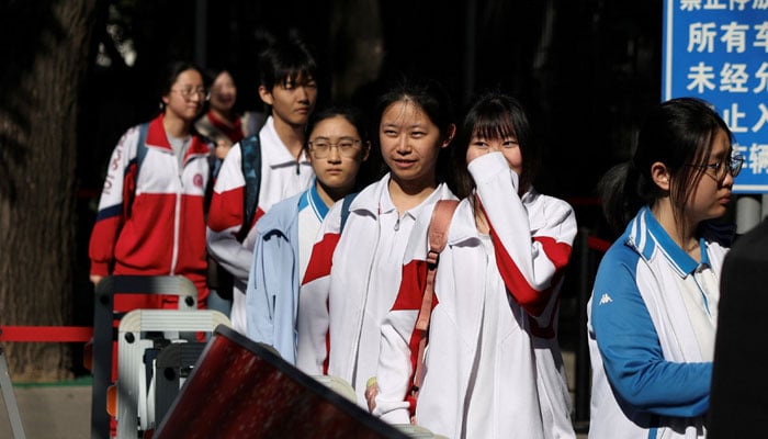 Students enter a high school to take part in the annual national college entrance exam, or gaokao, in Beijing, China June 7, 2026. — Reuters