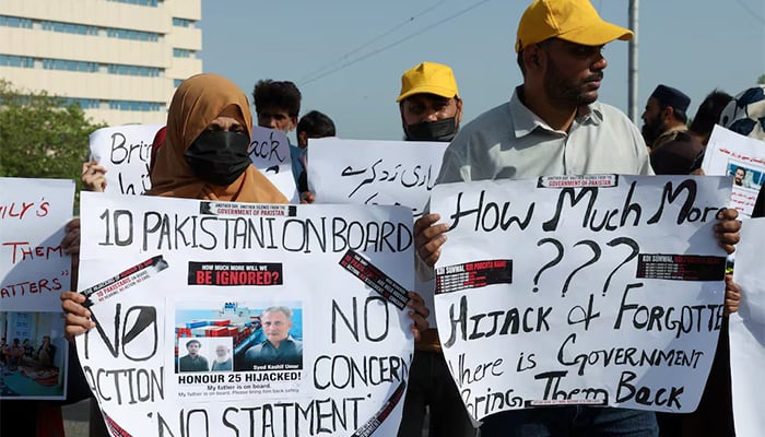 Families of the Pakistani hostage crew members of the Oil Products Tanker the HONOUR 25 that was hijacked by pirates off the coast of Somalia, hold placards during a protest, calling the government to take immediate action for the safe return of their loved ones, in Karachi, May 13, 2026. — Reuters