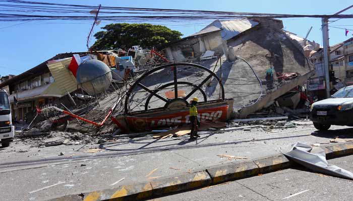 A worker walks near a collapsed building following the magnitude 7.8 quake in General Santos, southern Philippines, June 8, 2026.— Reuters