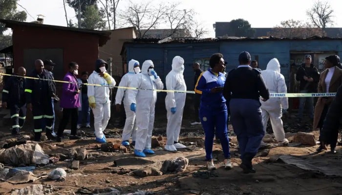 Members of the forensics team arrive at the scene after, according to the police, gunmen opened fire at an informal settlement in Cleveland, Johannesburg, South Africa, June 10, 2026. — Reuters