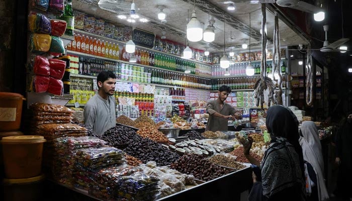 Shopkeepers serve customers at a dry fruit and grocery shop in Karachi, Pakistan June 2, 2026. — Reuters