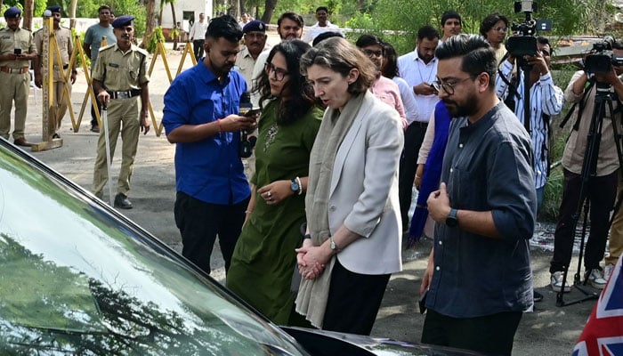 Lindy Cameron, British High Commissioner to India (C) pays tribute at Air India Flight 171 plane crash site on its first anniversary in Ahmedabad on June 12, 2026.— AFP