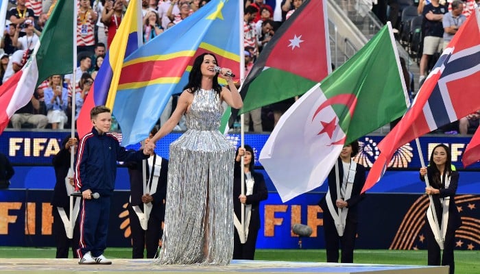American singer and songwriter Katy Perry performs with young singer Tius Luka ahead of the 2026 World Cup Group D football match between USA and Paraguay at the Los Angeles Stadium in Inglewood on June 12, 2026. — AFP