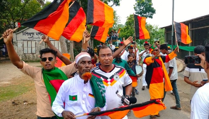 Football fans attend the unveiling of Germanys 7.5 kilometres (4.7 miles)-long national flag commissioned by Bangladeshi farmer Amjad Hossain (2L) in Magura district on June 10, 2026, on the eve of the 2026 FIFA World Cup tournament. — AFP