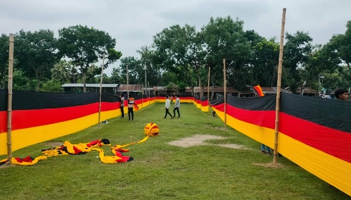 People look at a 7.5 kilometres (4.7 miles) long national flag of Germany commissioned by their football team fan, Bangladeshi farmer Amjad Hossain, upon its display across a field in Magura district, Bangladesh, on June 10, 2026, on the eve of the 2026 FIFA World Cup tournament. — AFP