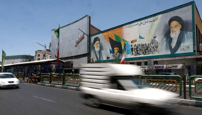 People drive past a mural depicting the late leader of the Islamic Revolution, Ayatollah Ruhollah Khomeini, and Irans late Supreme Leader Ayatollah Ali Khamenei, on a street in Tehran, Iran, June 14, 2026.— Reuters/File