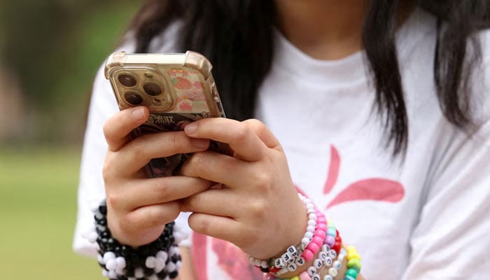 A representation image of a teenager using phone. — Reuters/File