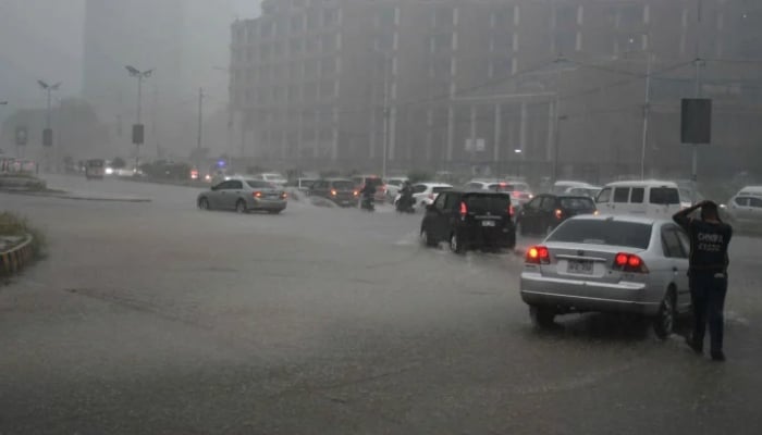 Motorists drive during heavy rainfall in Karachi. — Online/File
