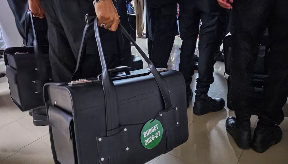 Police commandos carry bags containing copies of the 2026–27 fiscal budget at the Parliament House in Islamabad, June 12, 2026. — Reuters