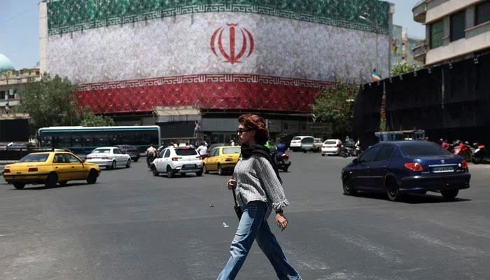 A woman walks on a street in Tehran, Iran, June 14, 2026. —Reuters