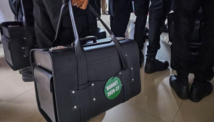 Police commandos carry bags containing copies of the 2026–27 fiscal budget at the Parliament House in Islamabad, on June 12, 2026. — Reuters