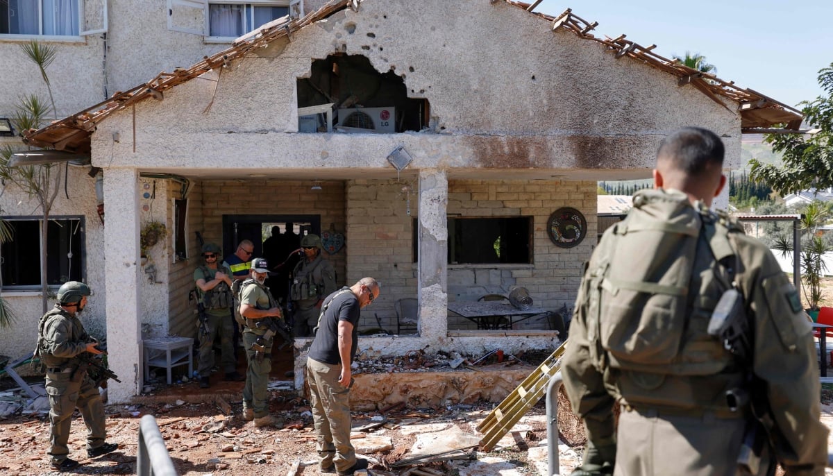 Israeli army and security forces conduct a search sweep of a house that was hit by Hezbollah projectiles in Moshav Kfar Yuval in northern Israel near the border with southern Lebanon on March 3, 2026. — AFP