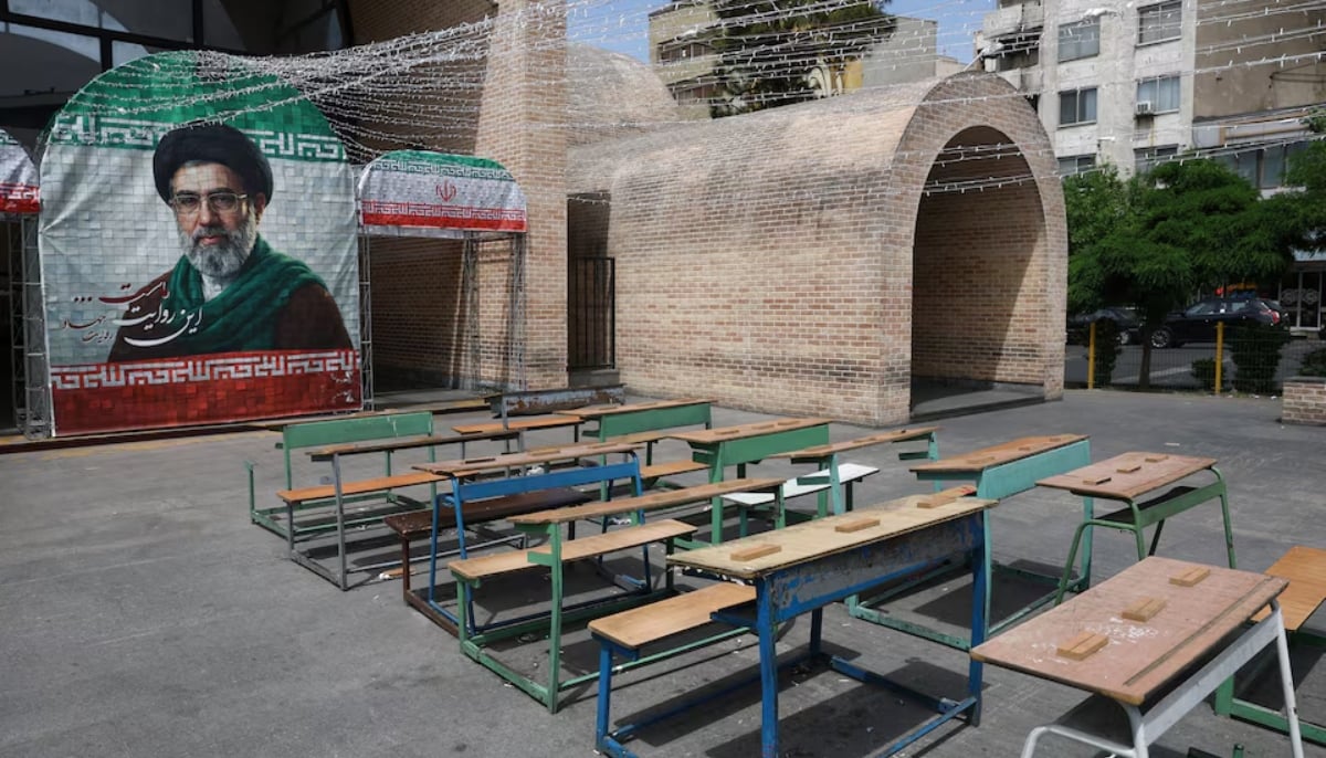 A banner with a picture of Irans new Supreme Leader, Mojtaba Khamenei, next to a symbolic classroom of the Minab school students who were killed in a strike, in Tehran, Iran, May 8, 2026. — Reuters
