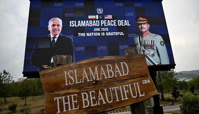 An electronic board featuring Prime Minister Shehbaz Sharif alongside COAS and CDF Field Marshal Asim Munir is displayed along a roadside in Islamabad on June 17, 2026. — AFP