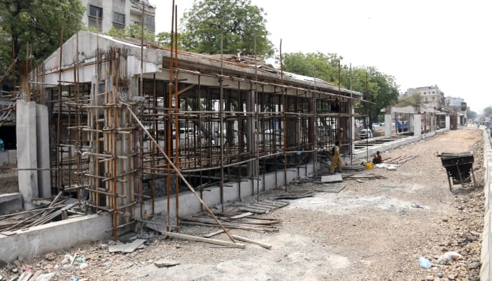 Labourers busy in construction of Green Line BRT station during extension work in Karachi on March31, 2026. — Online