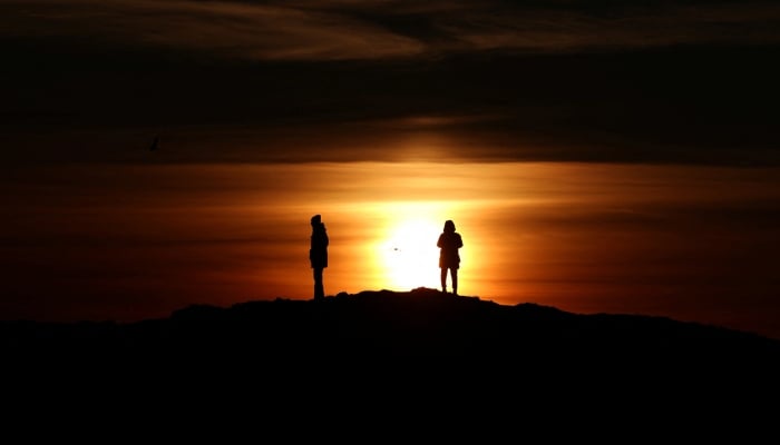 People stand on the shore as the Sun sets over Nuuk, Greenland, January 30, 2026. — Reuters