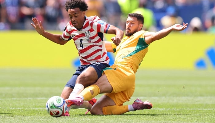 Tyler Adams #4 of the United States is tackled by Mathew Leckie #7 of Australia during the FIFA World Cup 2026 Group D match between USA and Australia at Seattle Stadium on June 19, 2026 in Seattle, Washington. — AFP