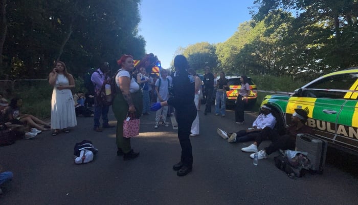 Emergency service workers and people gather near the scene of a collision involving two trains near Bedford, Britain, June 19, 2026. — Reuters