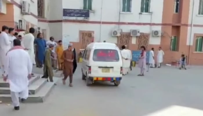 People gather outside a hospital as an ambulance shifts an injured person for treatment in Bannu on June 20, 2026. — Geo News