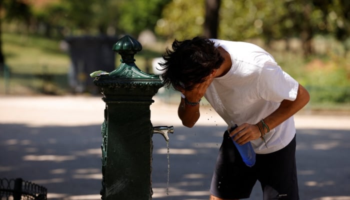 A person cools off from a water fountain in the Parc Monceau as temperatures rise in Paris during a second heatwave affecting a large part of France, June 19, 2026. — Reuters
