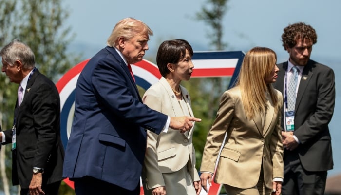 US President Donald Trump gestures next to Japanese Prime Minister Sanae Takaichi and Italian Prime Minister Giorgia Meloni following a group photo during the G7 summit in Evian-les-Bains, France, June 16, 2026.— Reuters