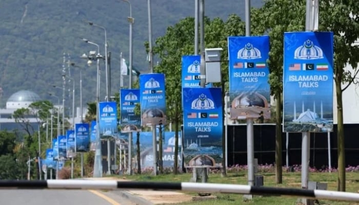 Hoardings are mounted on lamp posts, as Pakistan prepares to host the US and Iran for a possible second phase of talks in Islamabad, April 20, 2026. — Reuters