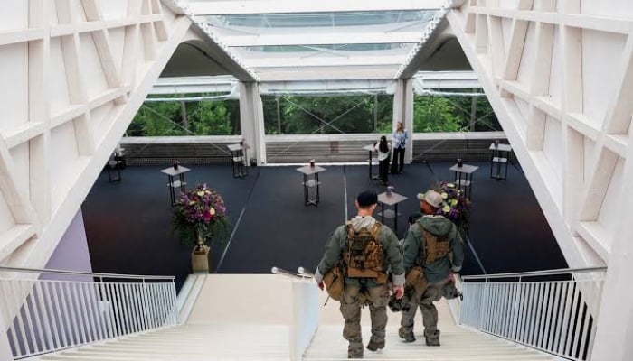 Secret Service police members walk down the stairs at Buergenstock Resort Lake Lucerne on the day of talks between the U.S., Iran, Pakistan, and Qatar at the Lake Lucerne Summit, aimed at advancing a deal to end the Middle East conflict, near Stansstad, Switzerland, June 21. — Reuters