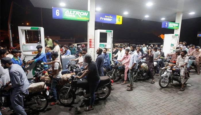 People wait their turn to get fuel at a petrol station, in Karachi, June 2, 2022. — Reuters