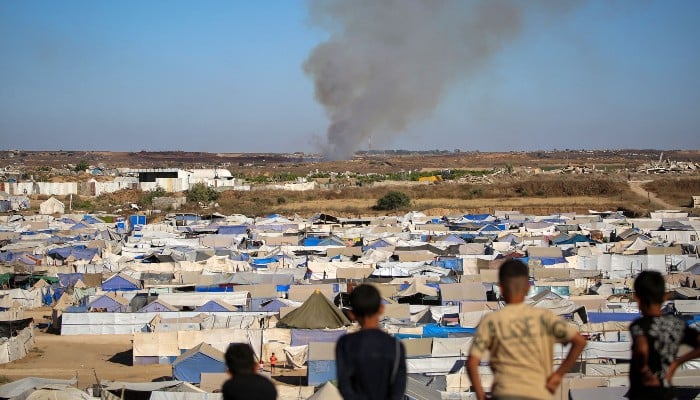 Israel targeted Gaza children resulting in genocide: UN inquiry 10 Children watch from atop a promontory overlooking shelters for people displaced by war, as smoke billows in the background near the Nuseirat camp for Palestinian refugees in the central Gaza Strip on June 19, 2026. — AFP