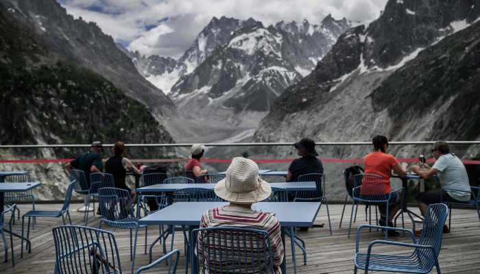 Tourists look at the Mont-Blanc massif mountains and the Mer de Glace glacier at the Montenvers station in the French Alps, central-eastern France on June 17, 2026. — AFP