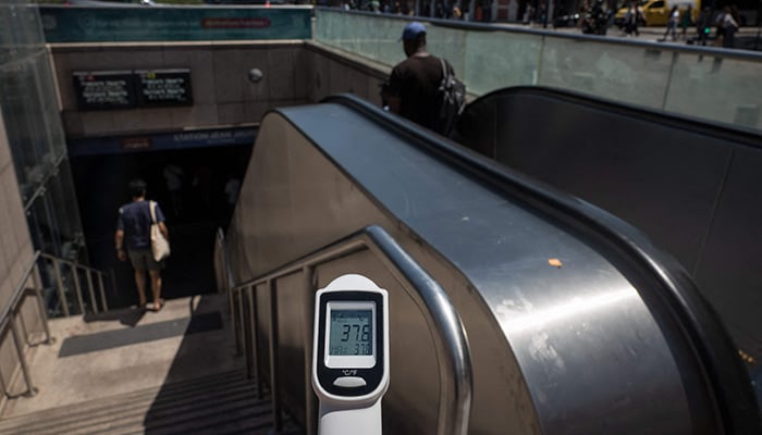 A thermometer shows the temperature of 37.6 degrees Celsius on a handrail leasing to a subway station, during a heatwave in Toulouse on June 23, 2026. — AFP