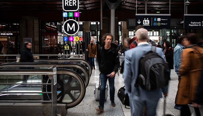 Commuters walk at the Gare du Nord, Europes busiest train station and the third in the world, on April 3, 2024 in Paris. — AFP