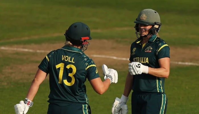 Australias Ellyse Perry (right) and Georgia Voll bump fists during their ICC Womens T20 World Cup match against Pakistan at Headingley in Leeds, June 23, 2026. — ICC