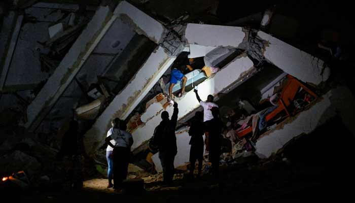 A person walks amid rubble of a destroyed building after an earthquake, in La Guaira, Venezuela, June 25, 2026.— Reuters