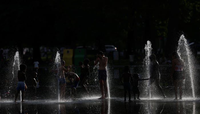 Children cool off in water jets at the Miroir deau (Mirror of Water) in Nantes during a heatwave affecting a large part of France, June 24, 2026. — Reuters