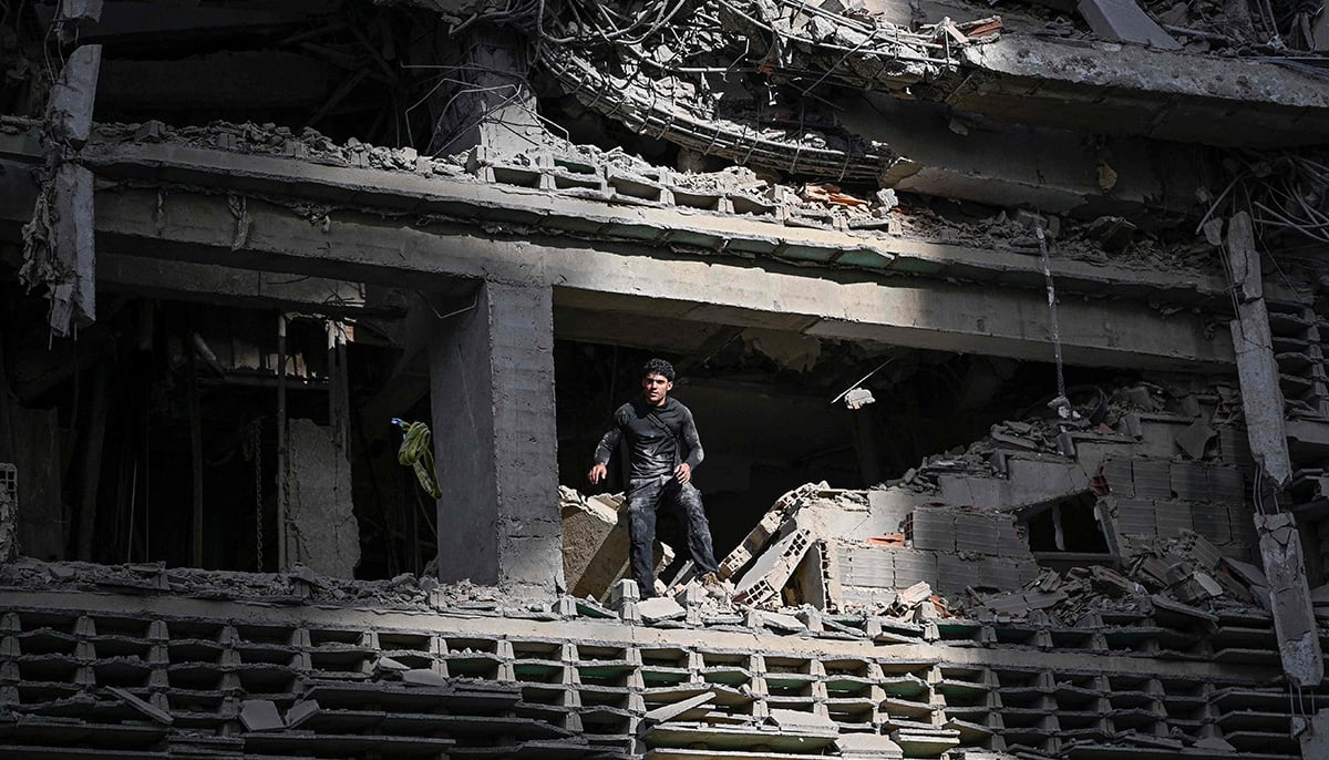 A man looks out from a damaged apartment building following an earthquake in Catia La Mar, La Guaira state, some 30km north-west of Caracas, on June 25, 2026. — AFP