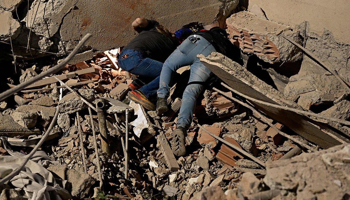 Rescue workers search through the rubble of a collapsed building in the Altamira neighbourhood following an earthquake in Caracas on June 24, 2026. — AFP