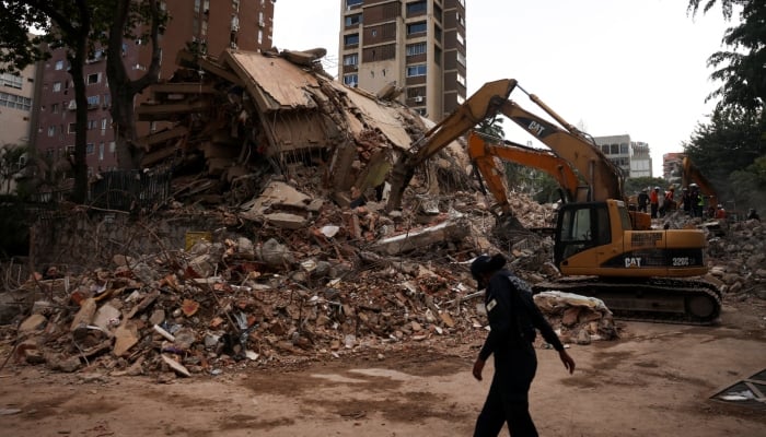 A person walks by the rubble of a collapsed building, in the aftermath of earthquakes in Caracas, Venezuela, June 25, 2026. — Reuters