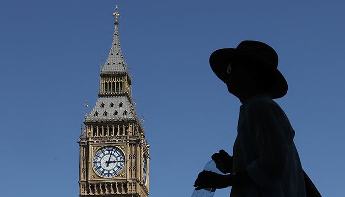 A person holds a water bottle whilst walking near Big Ben and the Houses of Parliament, in London, Britain, June 23, 2026. — Reuters