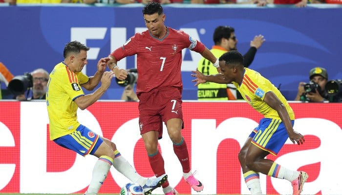 (L-R) Colombias defender #04 Santiago Arias, Portugal´s forward #07 Cristiano Ronaldo, and Colombias midfielder #11 Jhon Arias fight for the ball during the 2026 World Cup Group K football match between Colombia and Portugal at the Miami Stadium in Miami Gardens on June 27, 2026. — AFP