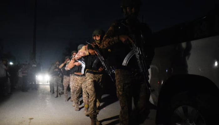 Security personnel patrols after an explosion and gunfire were reported near offices of the Rangers in Karachi, June 27, 2026. — Reuters