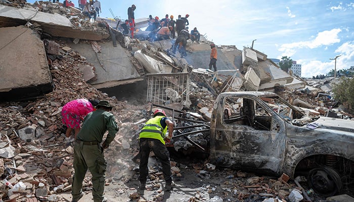 Rescuers and volunteers search for survivors on the rubble of a collapsed building in La Guaira state, Venezuela, on June 28, 2026, following earthquakes. — AFP