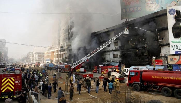 Smoke rises as firefighters spray water to extinguish a massive fire that broke out in the Gul Plaza Shopping Centre building, in Karachi on January 18, 2026. — Reuters
