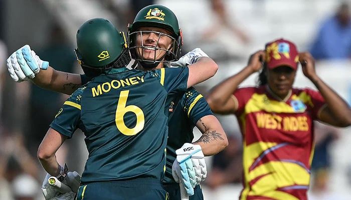 Australias Beth Mooney (left) and Australias Ashleigh Gardner (C-facing) embrace as they celebrate the teams victory in the ICC Womens T20 cricket World Cup 2026 semi-final game between Australia and West Indies, at The Oval in London on June 30, 2026. — AFP