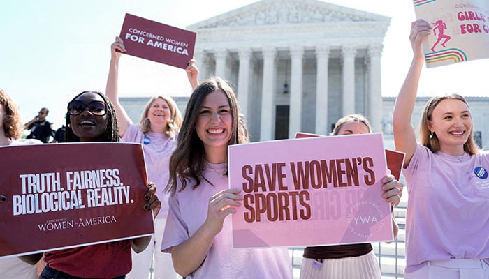 Women hold placards as they celebrate the US Supreme Courts final rulings of its nine-month term, including a decision that cleared the way for states to impose restrictions on transgender student athletes, in Washington, DC, US, June 30, 2026. — Reuters