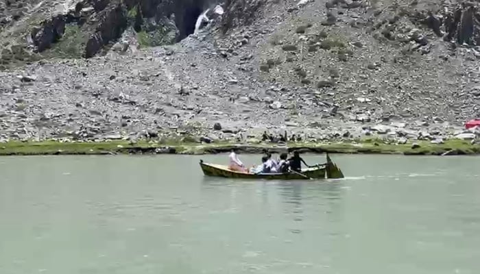 Tourists ride a boat at Saifullah Lake, a popular tourist attraction on the Swat River in Swat. — Geo News/File